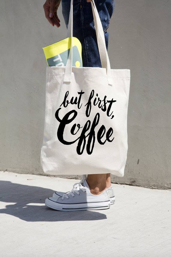 A custom-printed canvas tote bag carried on the street